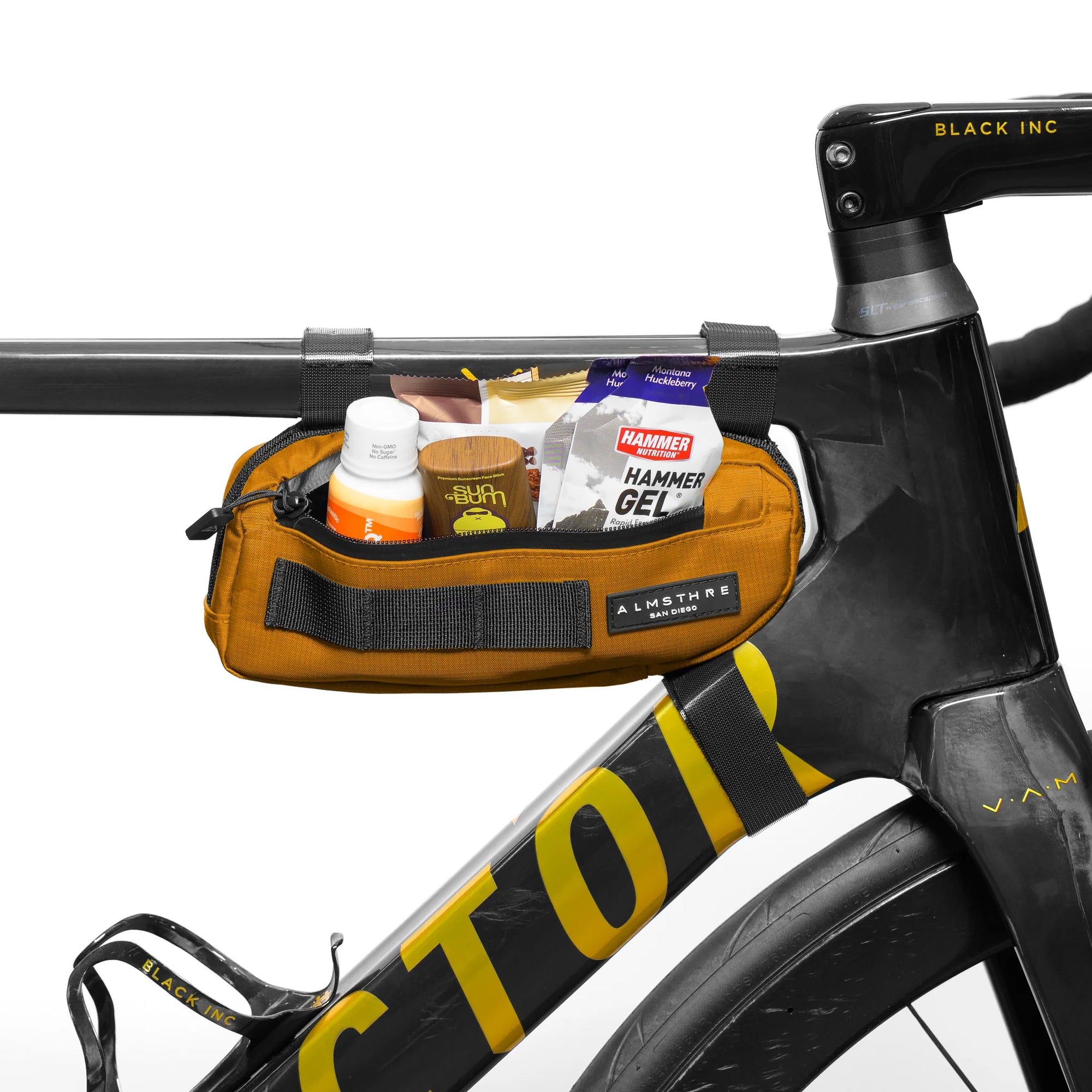 ALMSTHRE Compact Frame Bag mounted on bike frame with nutrition and essentials visible in mustard color