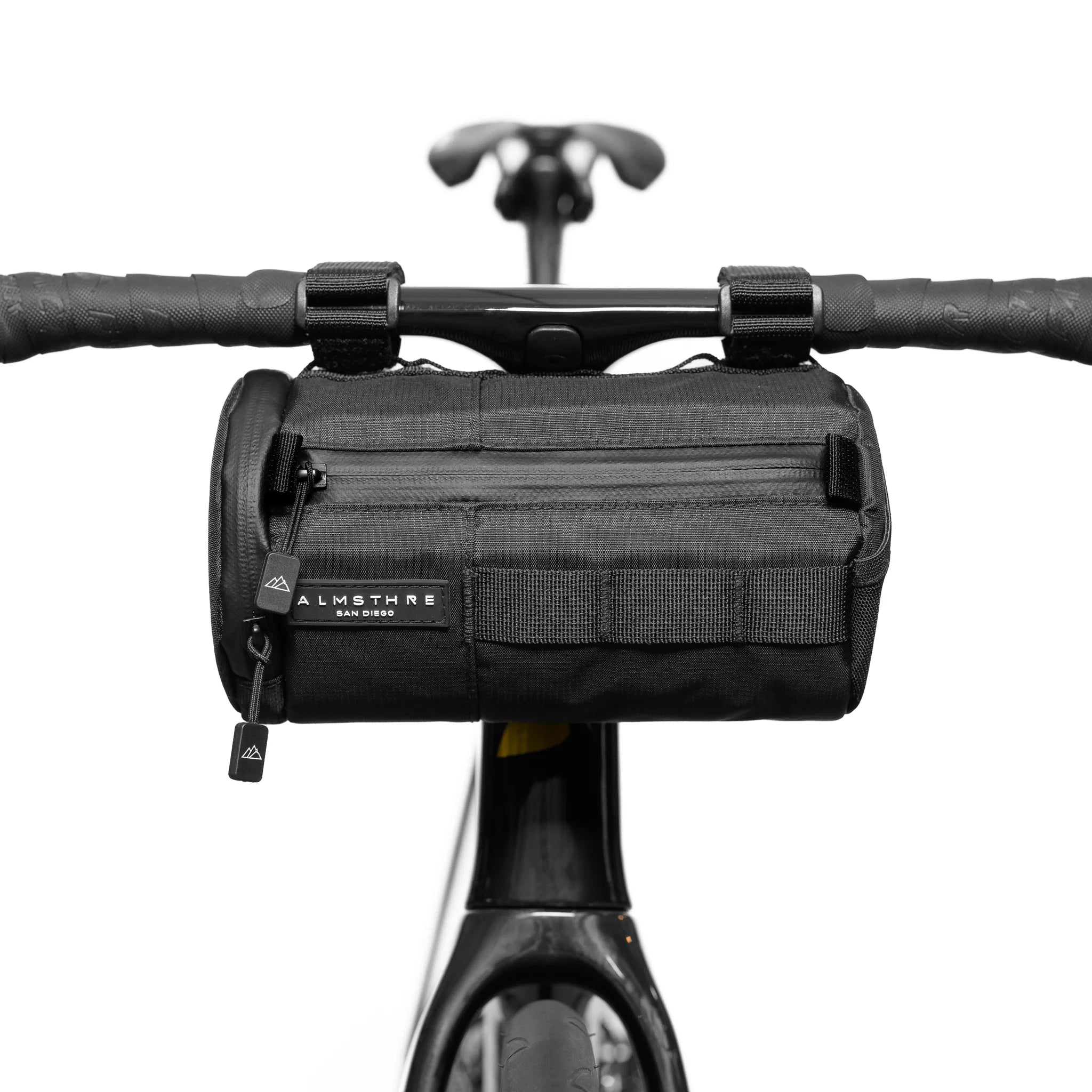 Front view of ALMSTHRE Signature Bar Bag attached to bike handlebar with zip pocket and secure straps