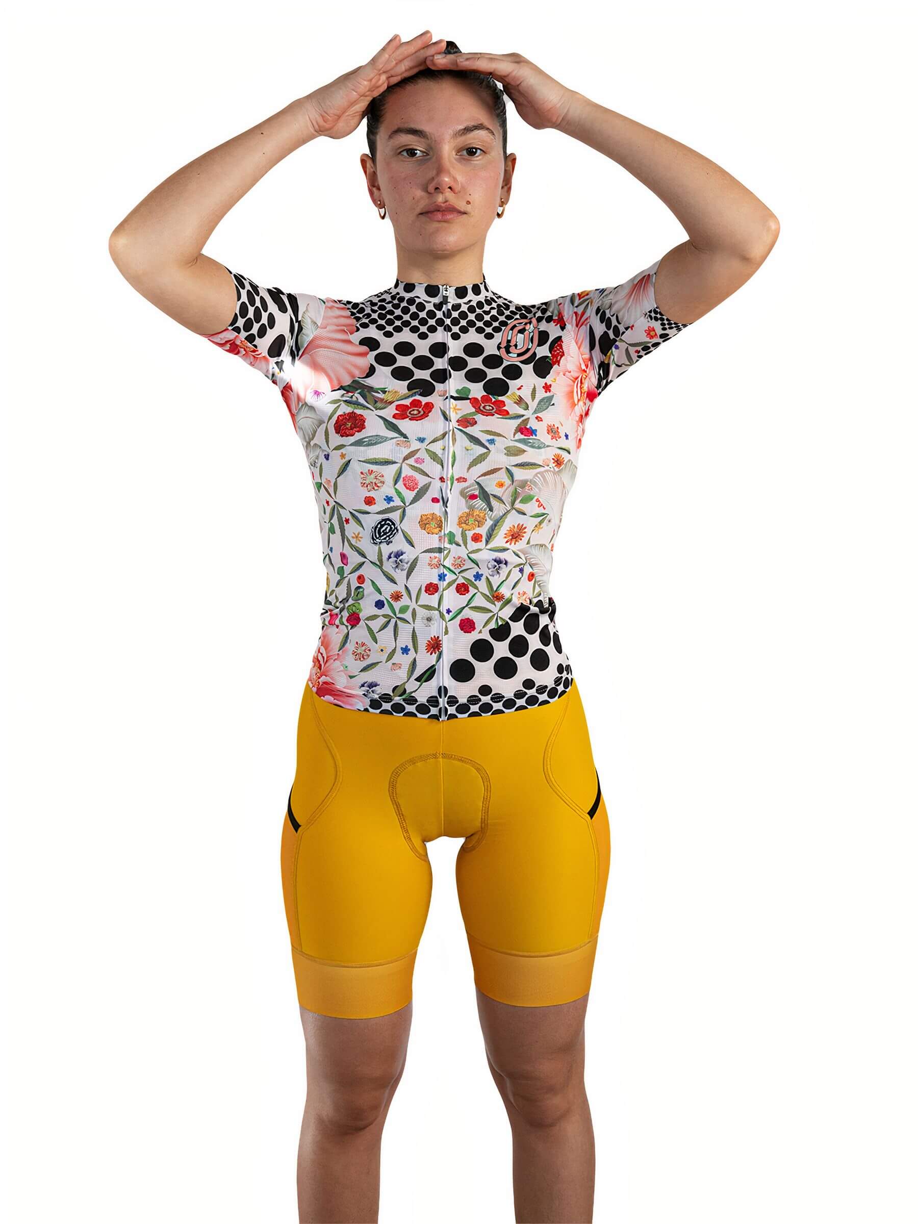 Woman wearing Ostroy Omloop White Jersey - Women's with floral and polka dot design standing against white background