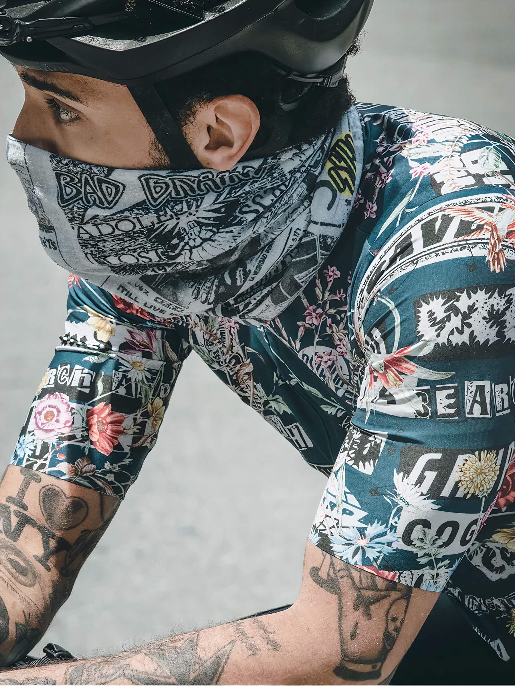 Cyclist wearing Ostroy Punk Flyers Neck Warmer with graphic punk flyer print and soft micro-polyester fabric