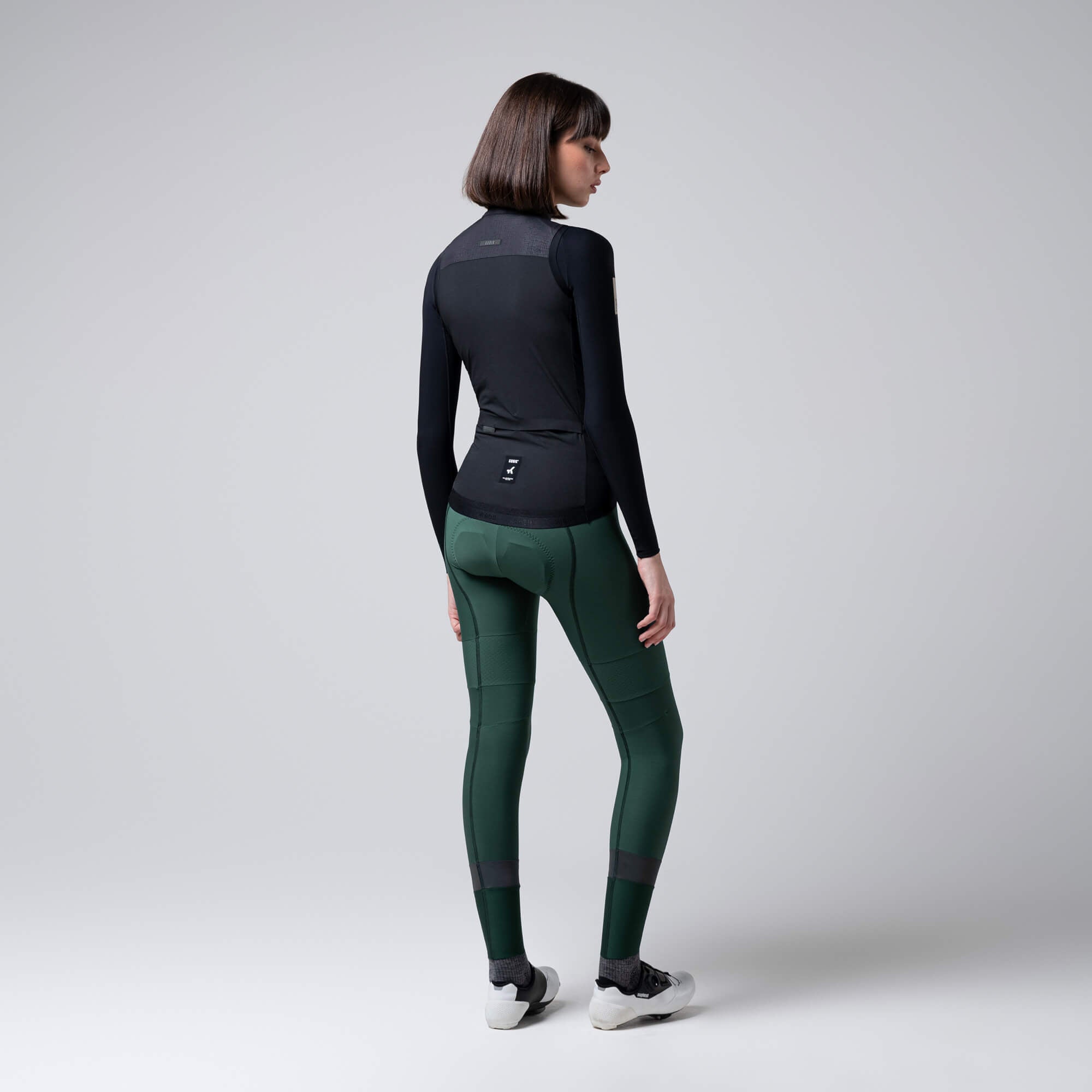 Rear view of woman wearing GOBIK Vector 2.0 Vest - Women's in black with fitted ergonomic cycling design