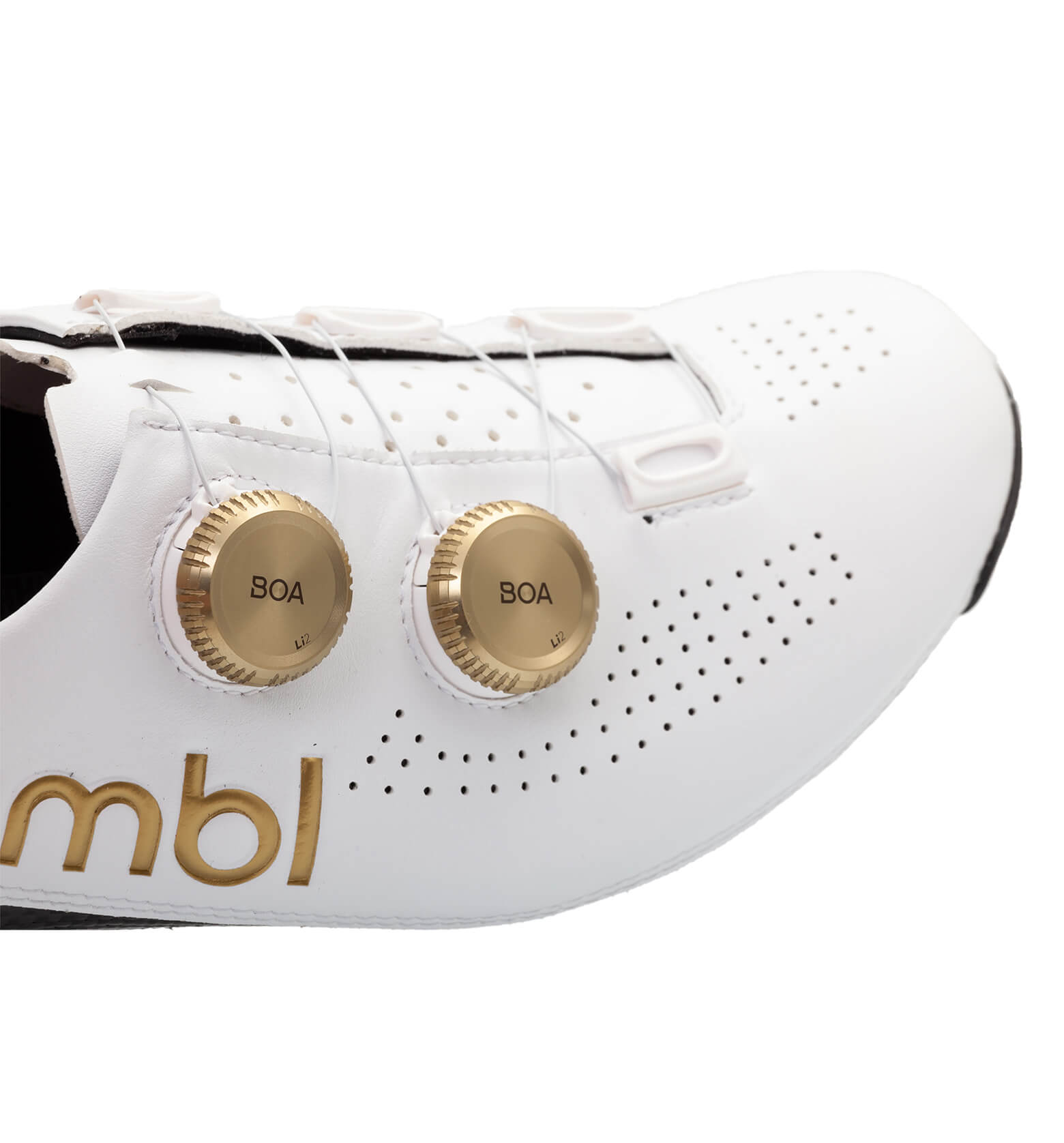 Close-up of white Nimbl ULTIMATE cycling shoe with gold BOA dials and perforated ventilation holes on side panel