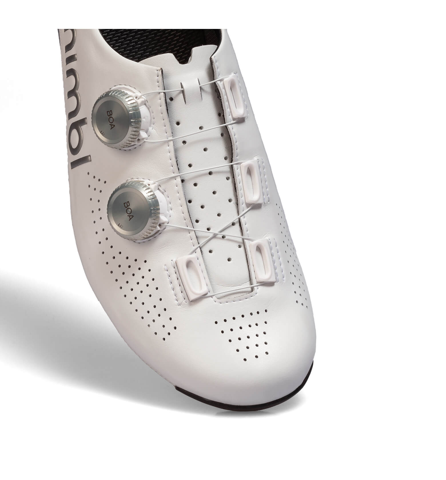 Close-up of white Nimbl ULTIMATE cycling shoe showing dual BOA dials and perforated upper for breathability and fit adjustment