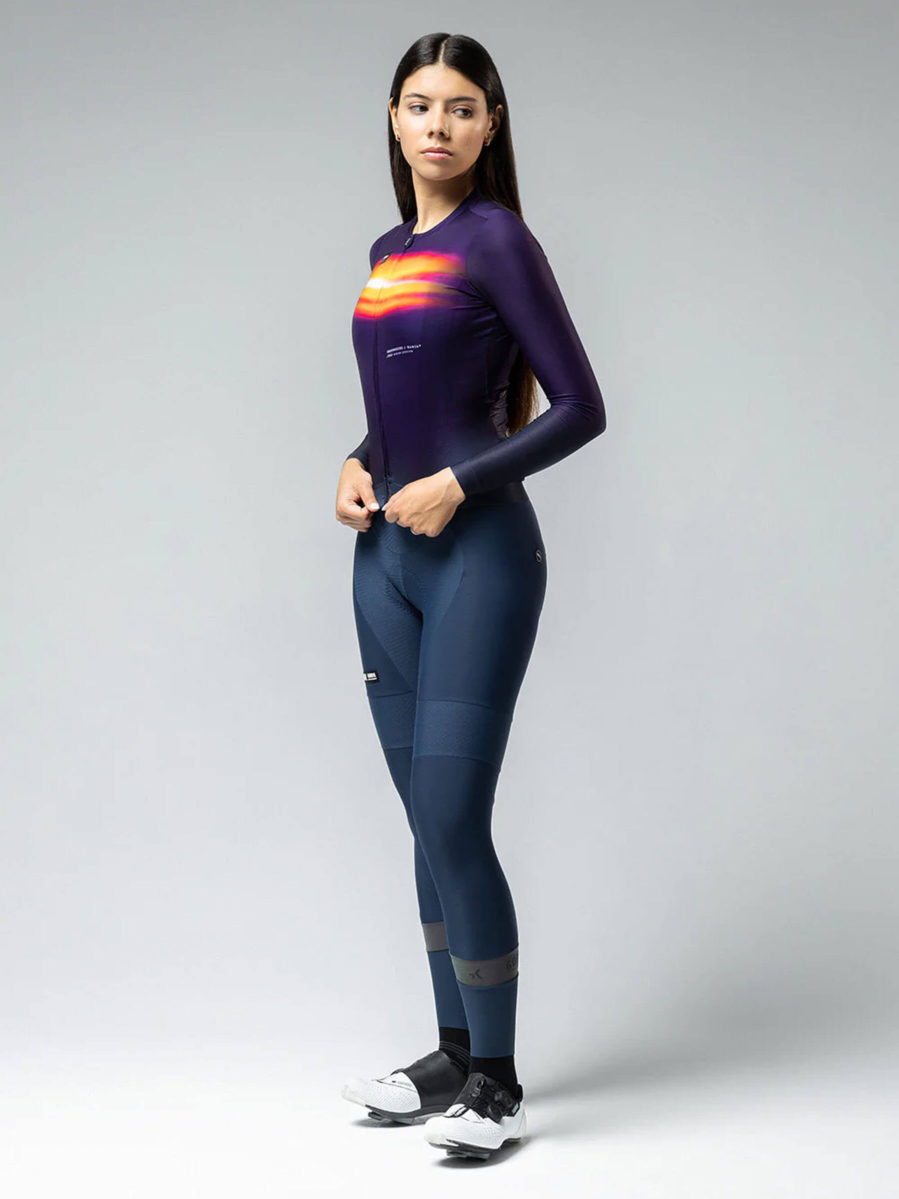 Female Cyclist showcasing the full Nebula kit, emphasizing the jersey's fit and performance features.